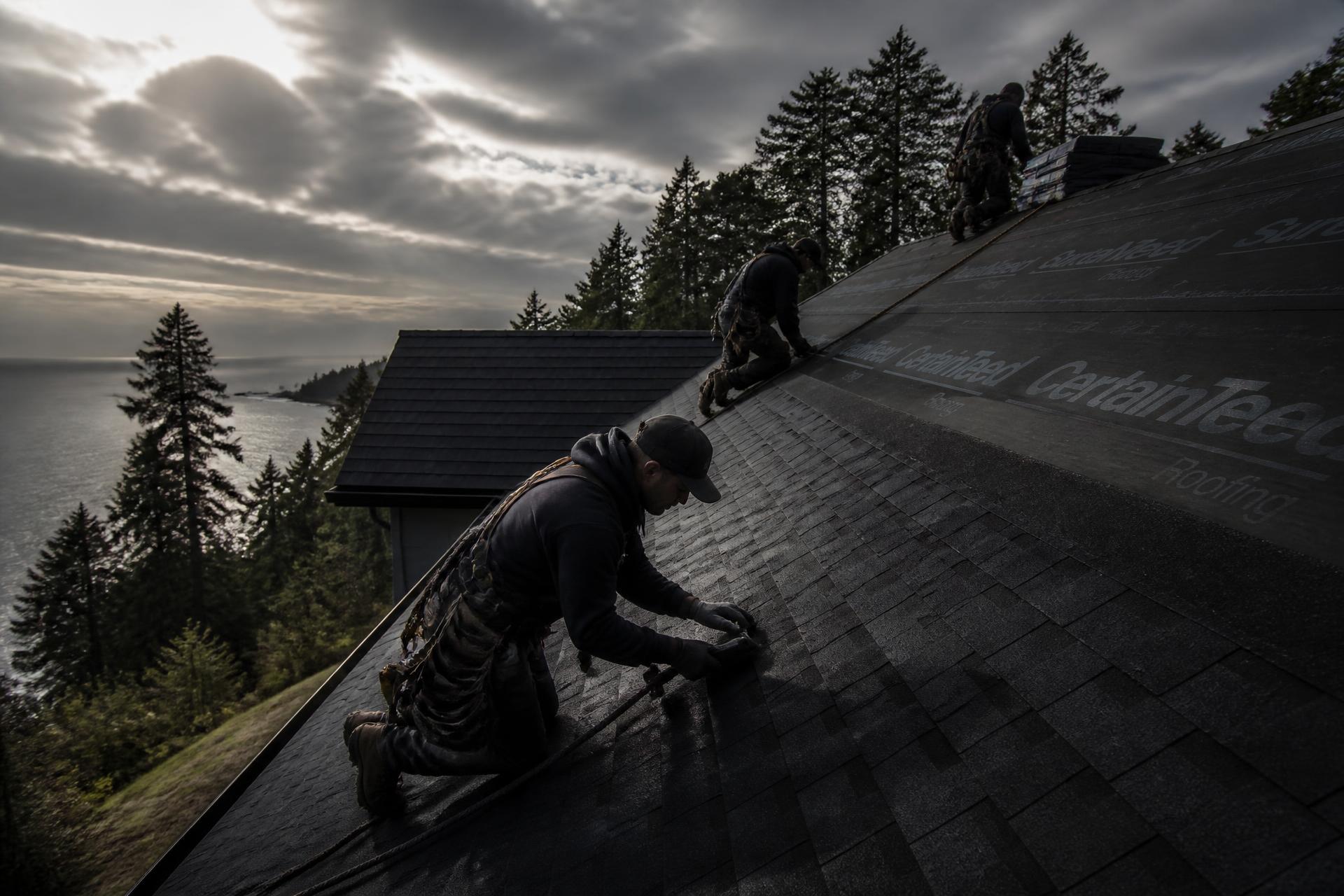 Roofing 911 crew installing shingles on a coastal Vancouver Island home